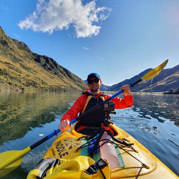 a man riding a surfboard on top of a mountain
