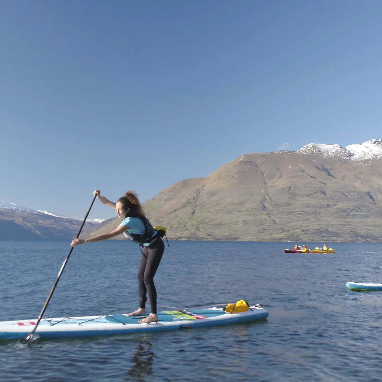 a group of people rowing a boat in a body of water