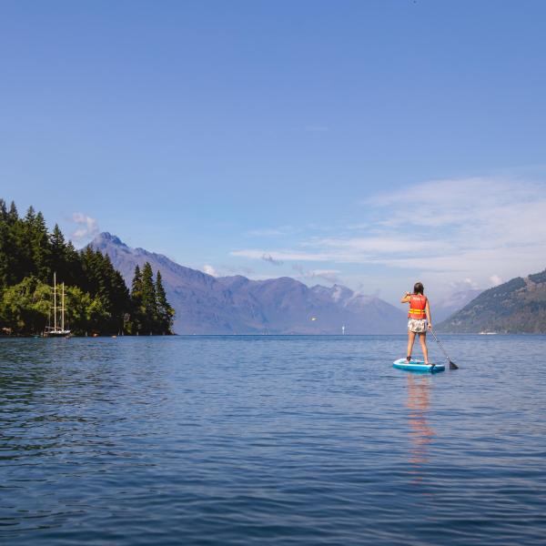 a man standing next to a body of water