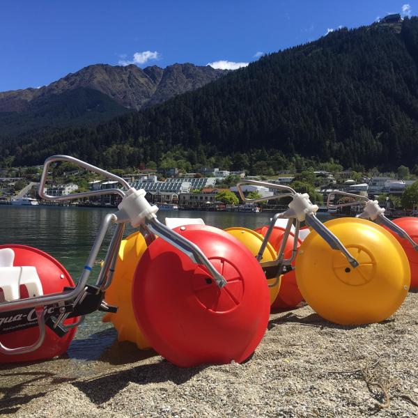 an orange motorcycle parked on the side of a mountain