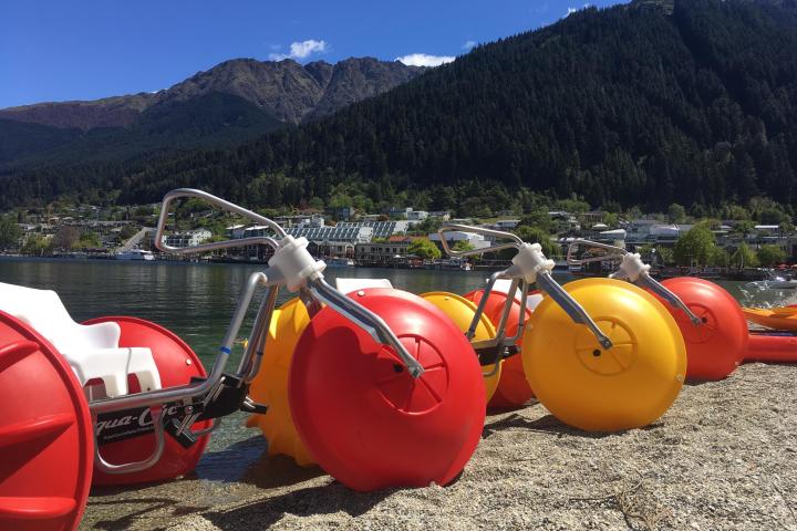 an orange motorcycle parked on the side of a mountain