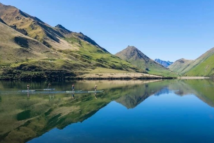 a body of water with a mountain in the background