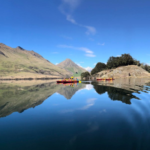 a body of water with a mountain in the background