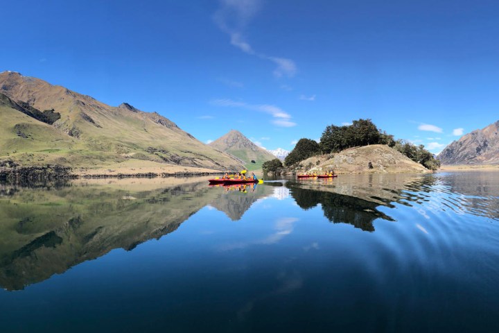 a body of water with a mountain in the background