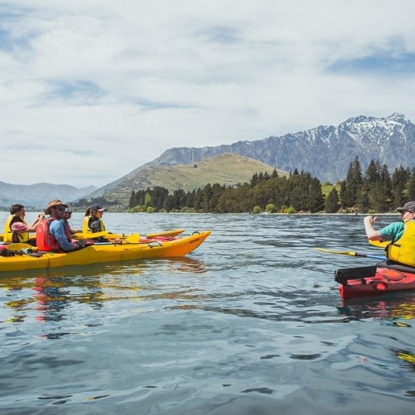 a group of people in a small boat in a body of water