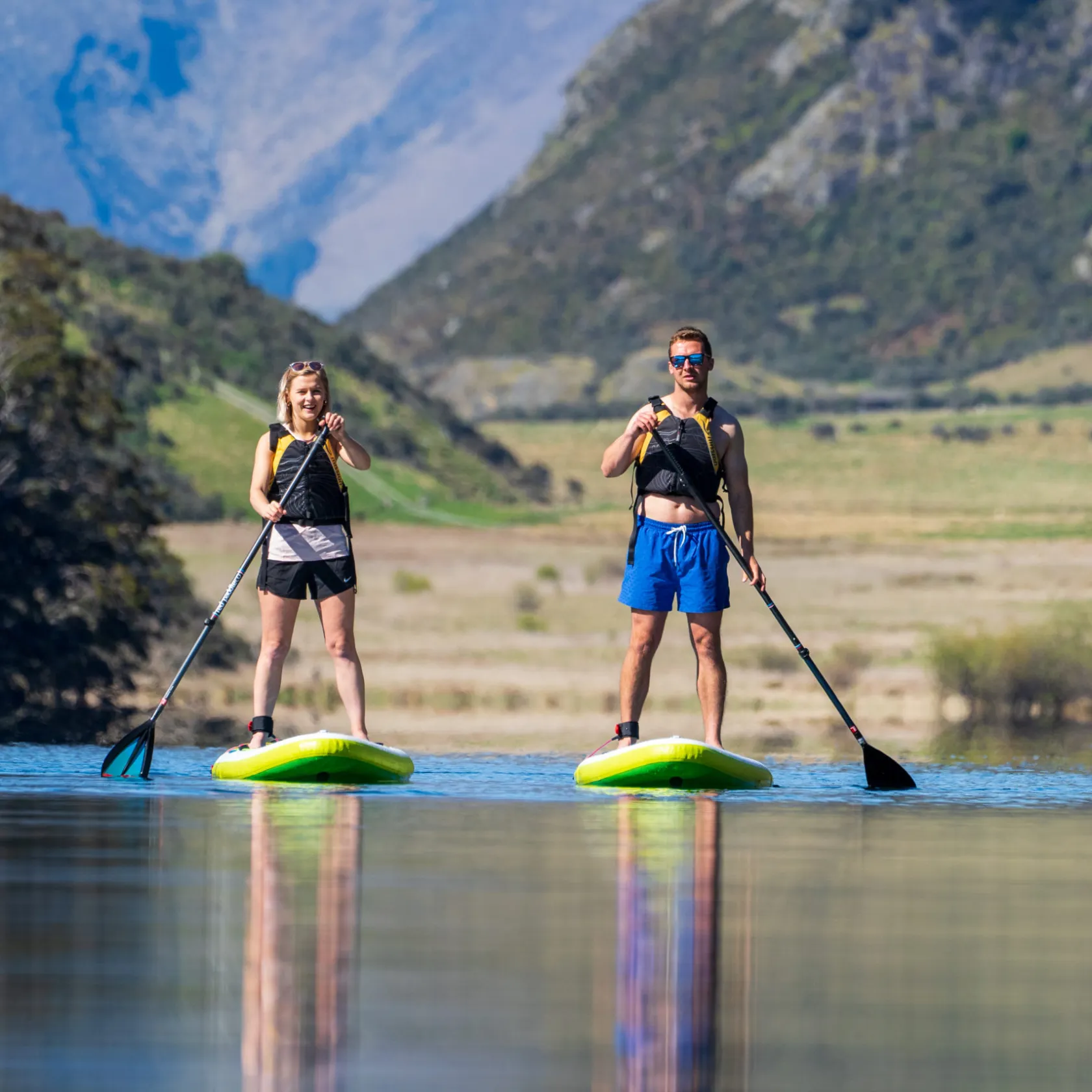 a little girl riding on top of a mountain