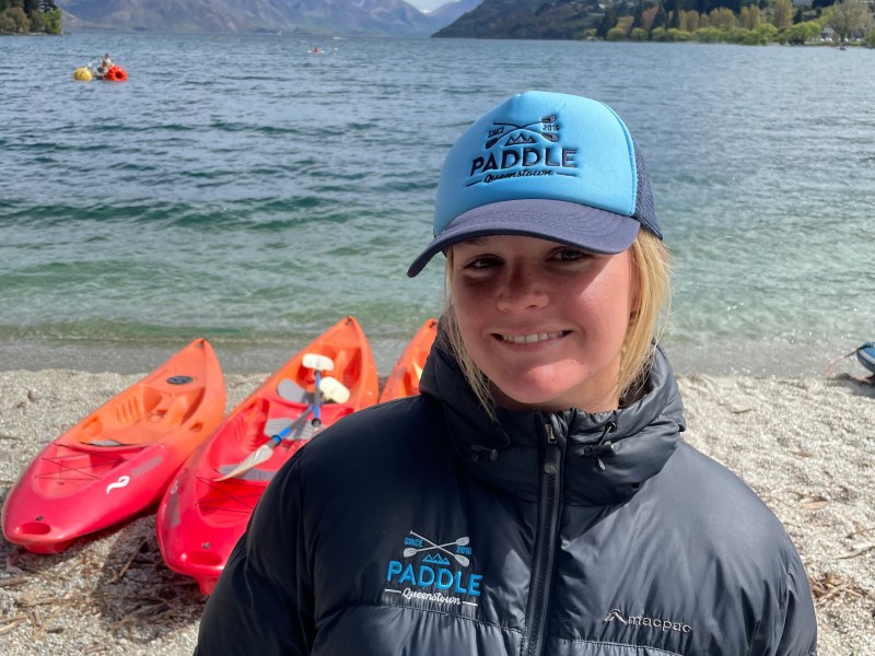 a person standing next to a body of water