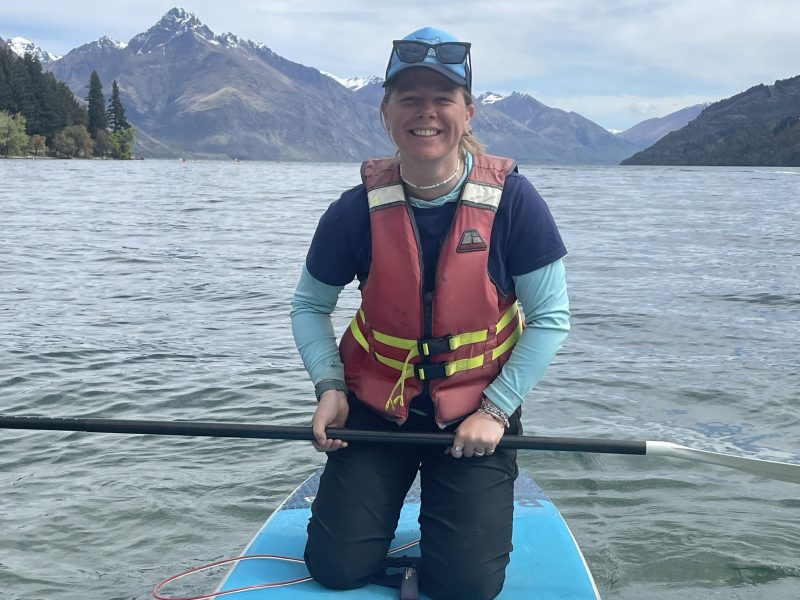 a person standing next to a body of water