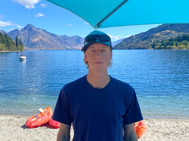 a man standing in front of a body of water